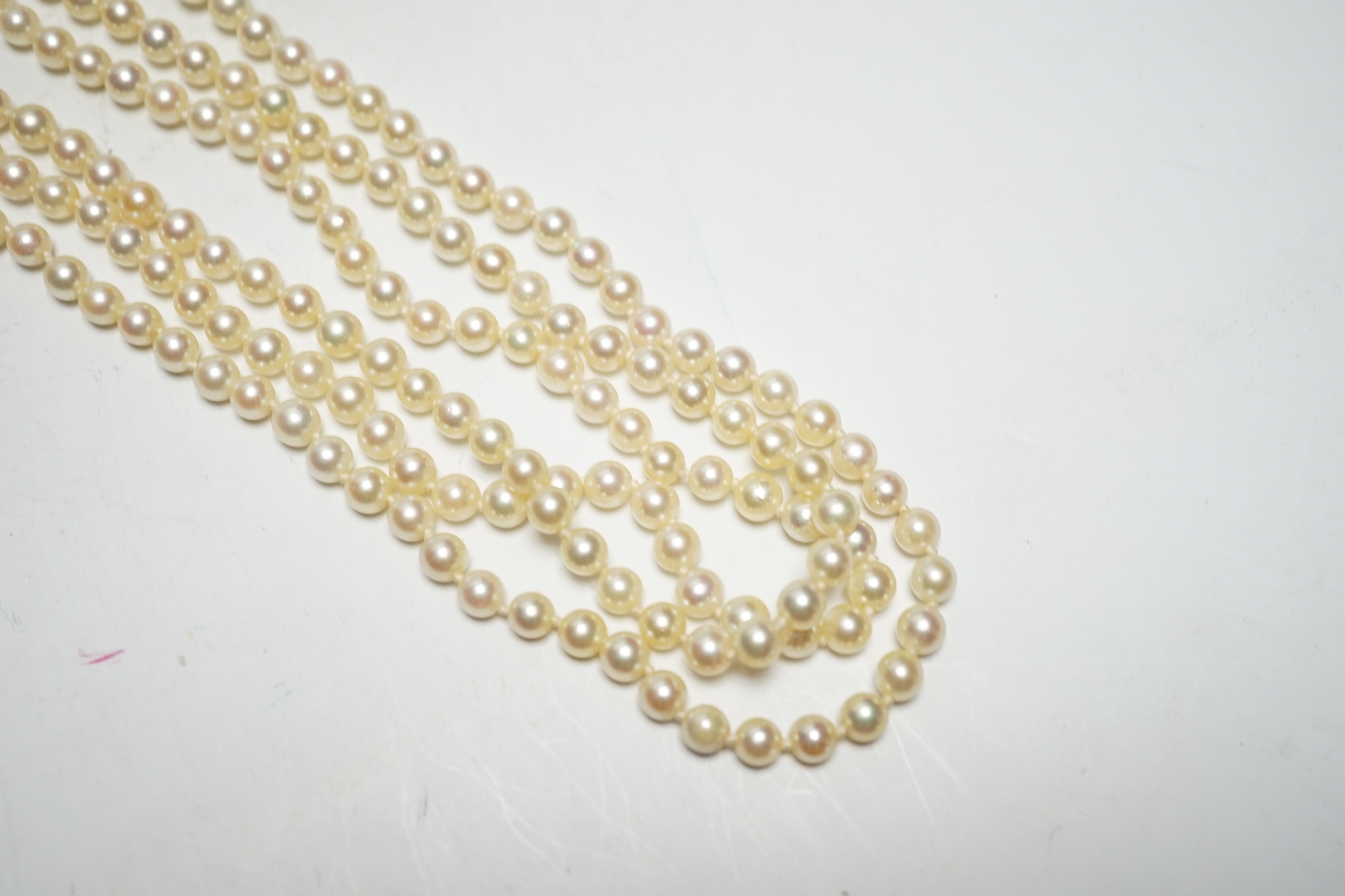 A 1960's triple strand cultured pearl necklace, by Cropp & Farr, with 9ct gold, garnet and seed pearl set clasp, 40cm.